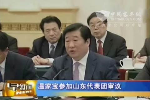 Wen is listening to speech delivered by Tan Xuguang