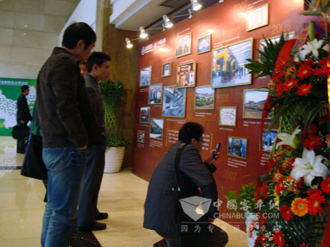 Customers watch historical and cultural background wall of Golden Dragon Bus