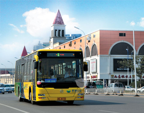 The hybrid bus of Golden Dragon is driving in the  road